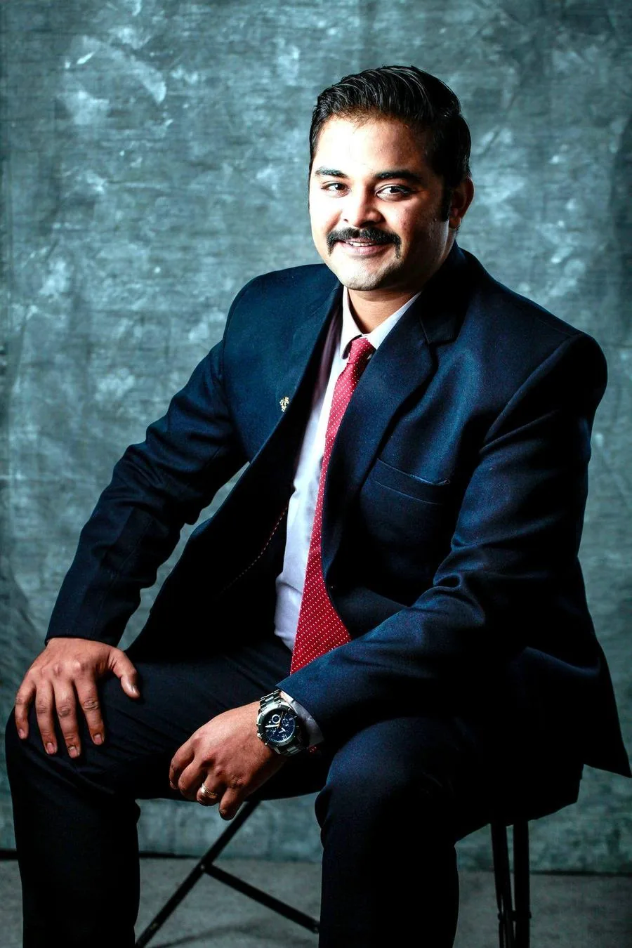 Vishvesh Patel smiling in a suit